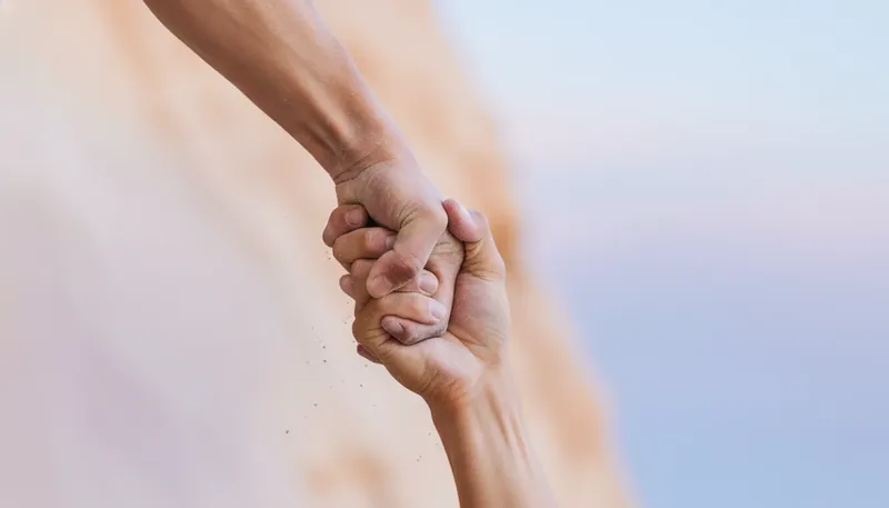 Two hands clasped in a gesture of trust, illustrating how to be a supportive partner when facing challenges together. filename: how-to-be-a-supportive-partner-bestie-ai.webp